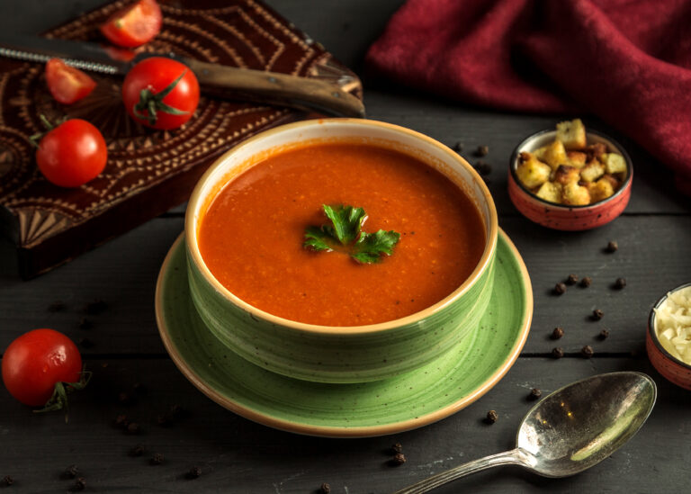 tomato soup with green on the table
